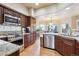Modern kitchen with stainless steel appliances, granite countertops, and dark wood cabinets at 3305 White Oak Ln, Highlands Ranch, CO 80129