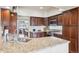 Well-appointed kitchen with granite countertops, stainless steel appliances, and dark wood cabinetry at 3305 White Oak Ln, Highlands Ranch, CO 80129