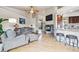 Inviting living room with a fireplace, hardwood floors, and an open floor plan to the kitchen at 3305 White Oak Ln, Highlands Ranch, CO 80129
