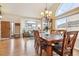 Bright living room with hardwood floors, large windows, and a view into another living space at 3305 White Oak Ln, Highlands Ranch, CO 80129