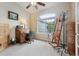 Bright home office featuring a classic roll-top desk, easel, and large window for ample natural light at 3305 White Oak Ln, Highlands Ranch, CO 80129