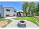 Beautiful backyard featuring artificial turf, a gazebo, a fire pit, and a large tree at 11000 Eudora Cir, Thornton, CO 80233