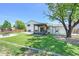 Spacious backyard featuring artificial turf, a gazebo, a fire pit, and a wooden fence at 11000 Eudora Cir, Thornton, CO 80233