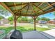 A backyard featuring artificial turf, a gazebo, a trailer, and a wooden fence at 11000 Eudora Cir, Thornton, CO 80233