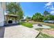 A backyard featuring artificial turf, a gazebo, a fire pit, and a concrete patio at 11000 Eudora Cir, Thornton, CO 80233