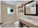 Finished basement bathroom with updated fixtures, tile floor, and window offering natural light at 11000 Eudora Cir, Thornton, CO 80233