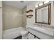 Updated bathroom featuring a shower-tub combo and modern sink with a decorative mirror at 11000 Eudora Cir, Thornton, CO 80233