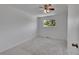 Bright bedroom with a ceiling fan, neutral walls, and a window with leafy green outdoor views at 11000 Eudora Cir, Thornton, CO 80233