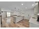 Open kitchen with island cooktop, stainless appliances, seamlessly flows into living room, perfect for entertaining at 11000 Eudora Cir, Thornton, CO 80233