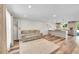 Open-concept living room featuring modern floors and a cozy seating area connected to kitchen at 11000 Eudora Cir, Thornton, CO 80233