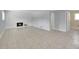 Open living room with a white brick fireplace and tiled floors and bright natural light at 11000 Eudora Cir, Thornton, CO 80233