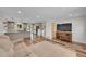 Spacious living room with view to the kitchen featuring wood floors and lots of natural light at 11000 Eudora Cir, Thornton, CO 80233
