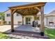 A covered outdoor patio features a wooden pergola with string lights, a barbecue, and sliding door access to the home at 11000 Eudora Cir, Thornton, CO 80233