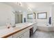 Spacious bathroom featuring a dual sink vanity, a soaking tub, and a large mirror at 5282 Devon Ave, Castle Rock, CO 80104