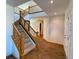 Grand two-story foyer with tiled floors, a wooden staircase, and an abundance of natural light at 5282 Devon Ave, Castle Rock, CO 80104