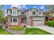 Two-story house with red brick accents, red door, and landscaping at 5282 Devon Ave, Castle Rock, CO 80104