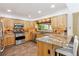 Modern kitchen with granite countertops, stainless steel appliances, and light wood cabinets at 5282 Devon Ave, Castle Rock, CO 80104