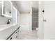 Modern bathroom featuring double vanity, illuminated mirrors, and separate tub at 41575 E 88Th Ave, Bennett, CO 80102
