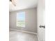 Bright bedroom featuring tile floors and large window with rural views at 41575 E 88Th Ave, Bennett, CO 80102