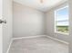 Simple, bright bedroom with ample sunlight and neutral gray tile flooring at 41575 E 88Th Ave, Bennett, CO 80102