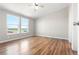 Bright bedroom featuring hardwood floors and large windows with rural views at 41575 E 88Th Ave, Bennett, CO 80102