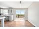 Sunlit dining area with laminate flooring and sliding glass doors to deck at 41575 E 88Th Ave, Bennett, CO 80102