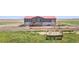 Exterior view of home with covered porch and well-maintained landscaping at 41575 E 88Th Ave, Bennett, CO 80102