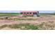 Aerial view of a quaint home featuring a front deck and sprawling, mostly barren land at 41575 E 88Th Ave, Bennett, CO 80102