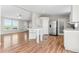Open-concept living area with wood-look floors, neutral tones, and great natural light at 41575 E 88Th Ave, Bennett, CO 80102