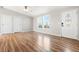 Living room featuring laminate flooring, bright neutral paint, and a contemporary front door at 41575 E 88Th Ave, Bennett, CO 80102