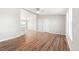 Open-concept living room with hardwood floors and bright, neutral walls at 41575 E 88Th Ave, Bennett, CO 80102