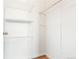 Spacious walk-in closet with adjustable shelving and hardwood flooring at 41575 E 88Th Ave, Bennett, CO 80102