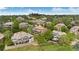 Aerial view of a brick home with multiple decks, surrounded by lush greenery and other upscale residences at 2595 S Harlan Ct, Lakewood, CO 80227