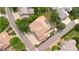 Aerial view showcases a property with a well-manicured lawn, brickwork, and outdoor seating area at 2595 S Harlan Ct, Lakewood, CO 80227