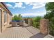 Relaxing outdoor seating area on a spacious deck with scenic views of mountains and trees at 2595 S Harlan Ct, Lakewood, CO 80227