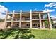 Beautiful backyard with multiple levels of balconies with brick supports and lush green grass at 2595 S Harlan Ct, Lakewood, CO 80227