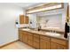 Primary bathroom features double sink vanity with granite countertop, bathtub, and tile flooring at 2595 S Harlan Ct, Lakewood, CO 80227