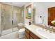 Bathroom featuring a glass shower, toilet, mirror, and sink at 2595 S Harlan Ct, Lakewood, CO 80227