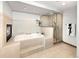 Luxurious bathroom featuring a soaking tub with fireplace and a glass-enclosed shower at 2595 S Harlan Ct, Lakewood, CO 80227