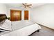 Comfortable bedroom features soft carpet, a wood closet and ceiling fan with recessed lighting at 2595 S Harlan Ct, Lakewood, CO 80227