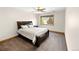 Comfortable bedroom with a dark wood frame bed, carpeted floors, and bright window at 2595 S Harlan Ct, Lakewood, CO 80227