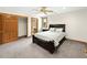Bright bedroom featuring a closet, ceiling fan, window, and carpeted floors at 2595 S Harlan Ct, Lakewood, CO 80227