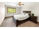 Bright bedroom with a cozy bed, a window with view, and ceiling fan at 2595 S Harlan Ct, Lakewood, CO 80227