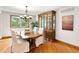 Elegant dining room with a large table, classic hutch, and bright window at 2595 S Harlan Ct, Lakewood, CO 80227