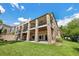 Multi-level brick home features large balconies and a spacious green lawn at 2595 S Harlan Ct, Lakewood, CO 80227