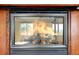Close-up of a stunning fireplace with intricate detailing and a cozy fire burning at 2595 S Harlan Ct, Lakewood, CO 80227