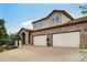 Charming two-story home with a brick facade, two-car garage, and well-manicured landscaping at 2595 S Harlan Ct, Lakewood, CO 80227