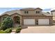 Elegant two-story home featuring a brick and stucco facade, well-manicured landscaping, and a spacious two-car garage at 2595 S Harlan Ct, Lakewood, CO 80227