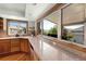 Bright kitchen features granite counters, wood cabinets, hardwood floors and a large window overlooking the backyard at 2595 S Harlan Ct, Lakewood, CO 80227