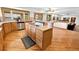 Stylish kitchen island with a cooktop and hardwood floors with an open concept layout at 2595 S Harlan Ct, Lakewood, CO 80227